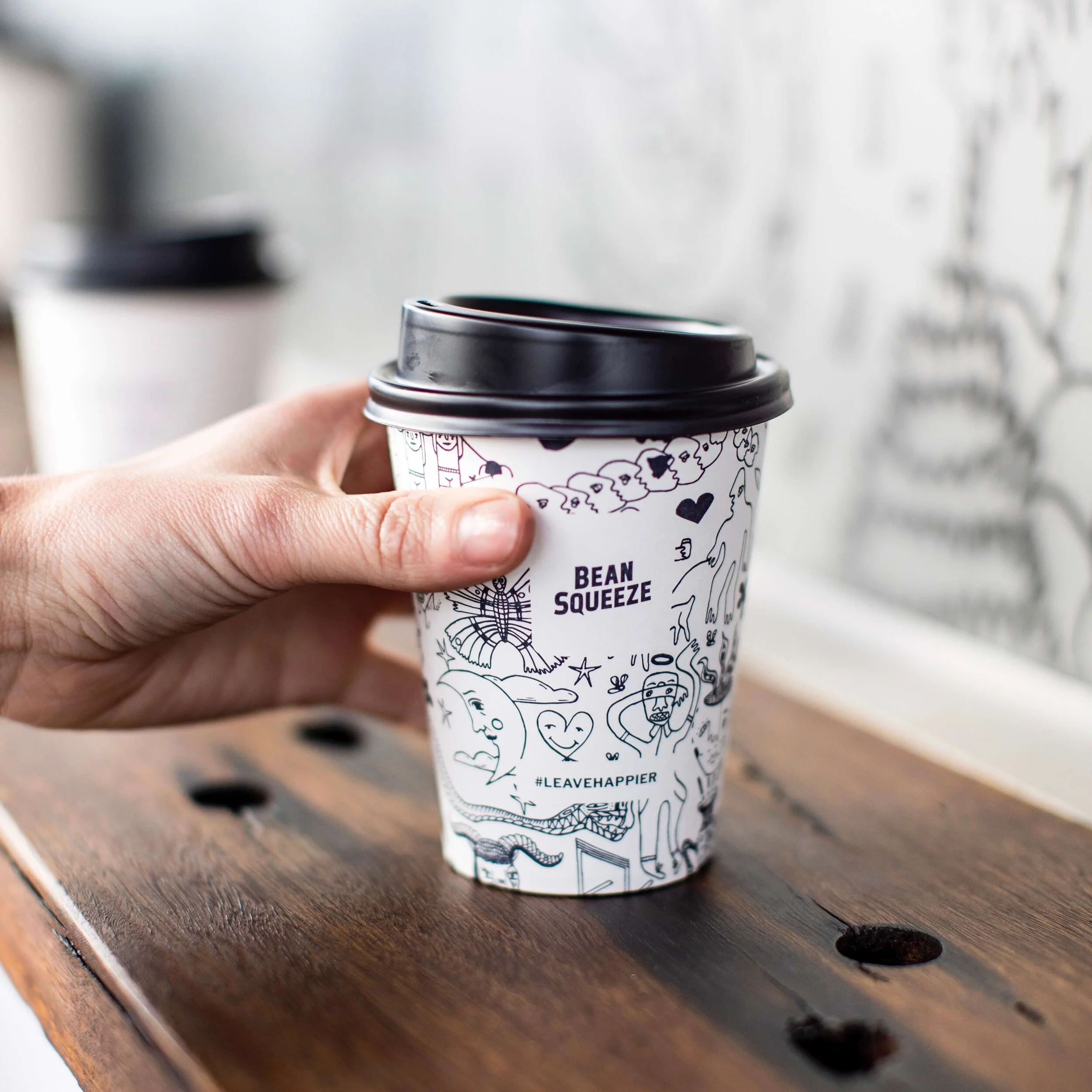 Coffee in an illustrated takeaway cup